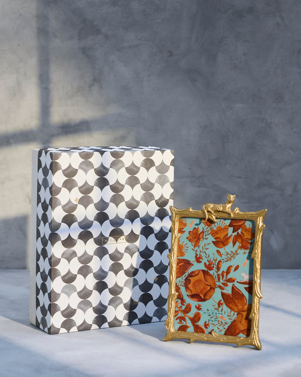 The frame beside its grey and white checked gift box