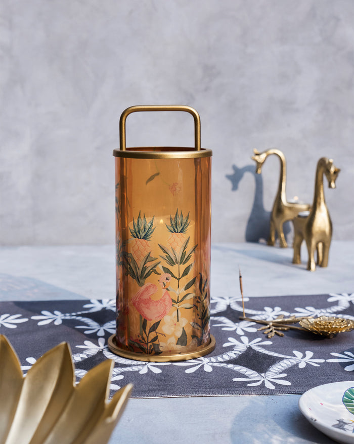 Flamingo Lantern in amber glass with a gold handle and printed flowers.