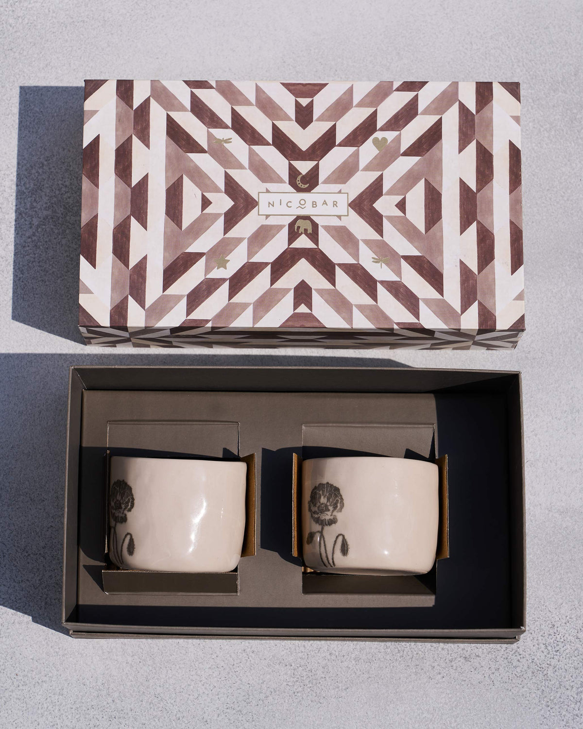Poppy mug set of two packed in an open Nicobar gift box.