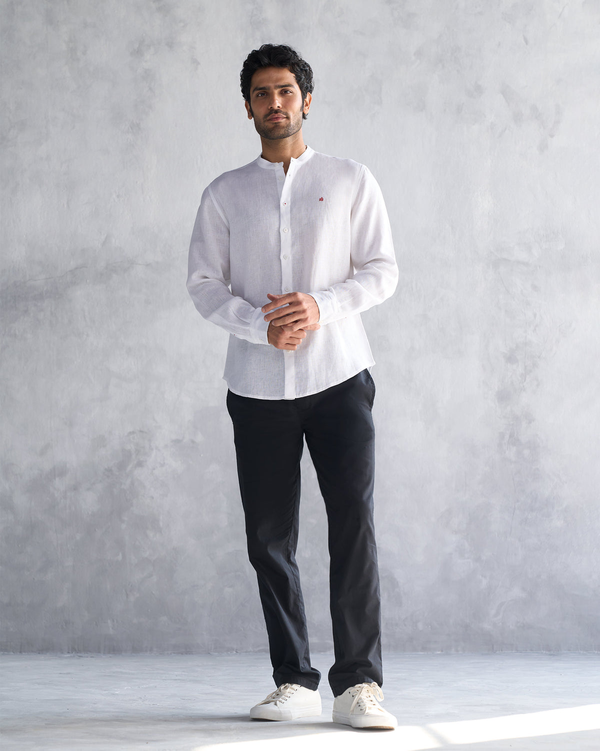 Person wearing a white Nawab shirt with a Nehru collar.
