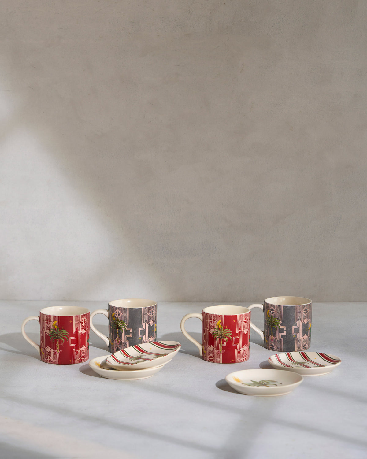Leafy Affair gift set of palm-motif mugs and matching tea plates.