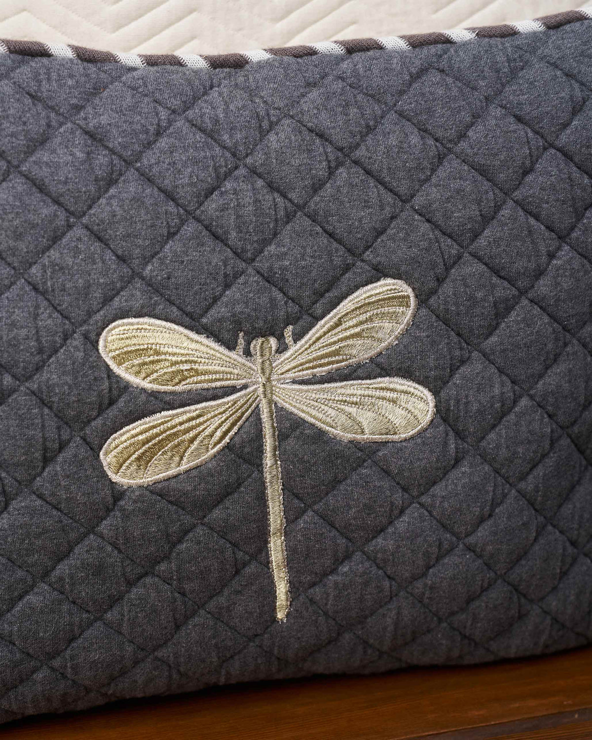 Close-up of the Quilted Dragonfly Cushion Cover showing its embroidered dragonfly.