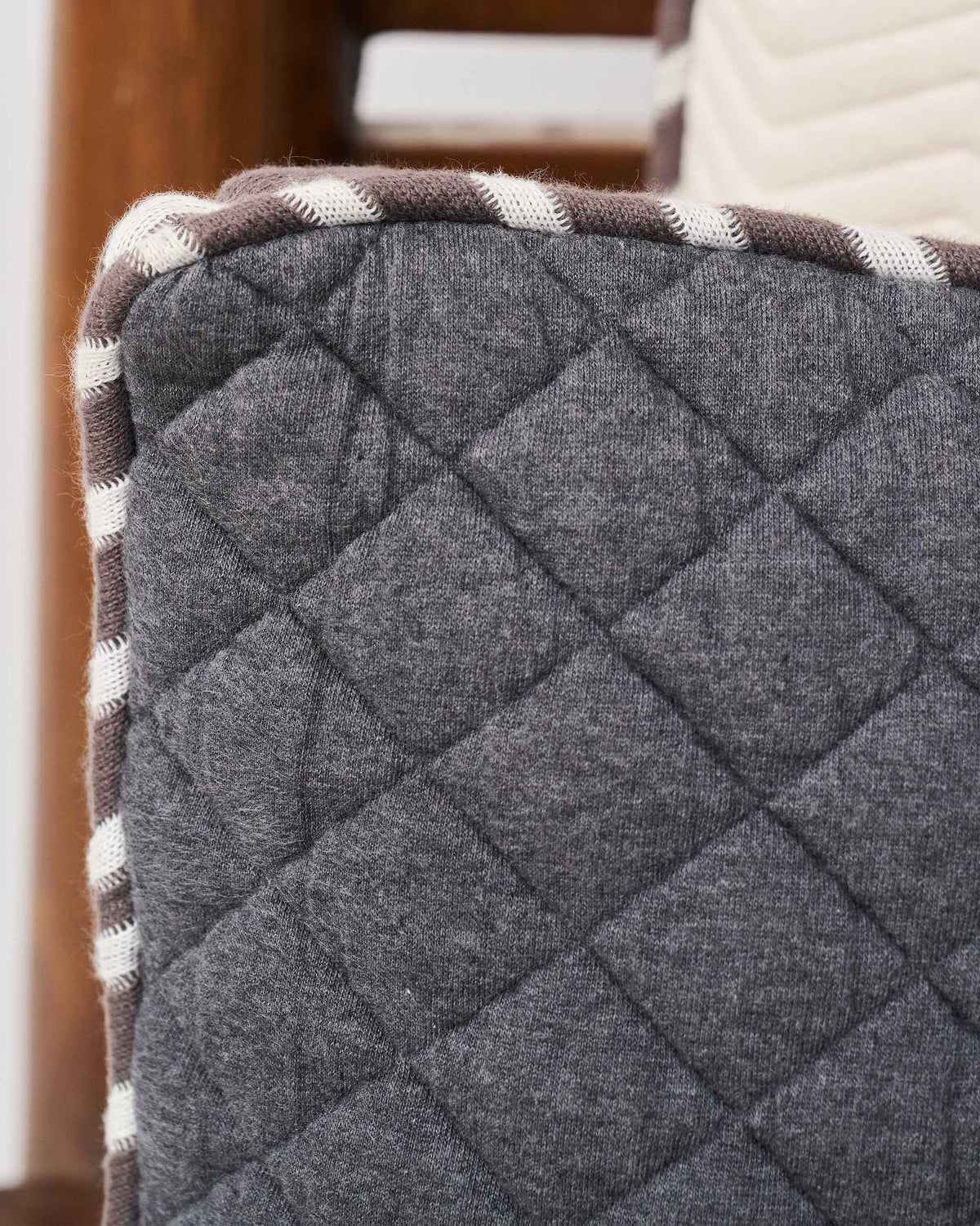 Close-up of the Quilted Dragonfly Cushion Cover's diamond quilting and piping edge.