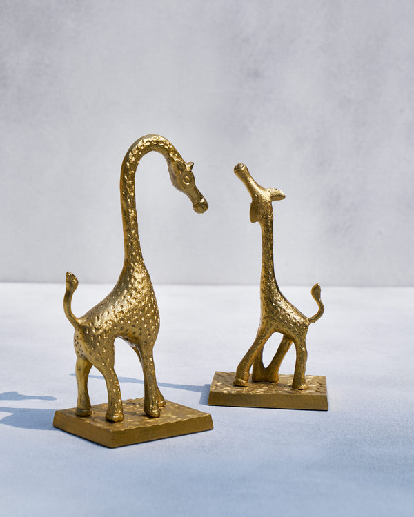 The giraffes facing each other on square bases