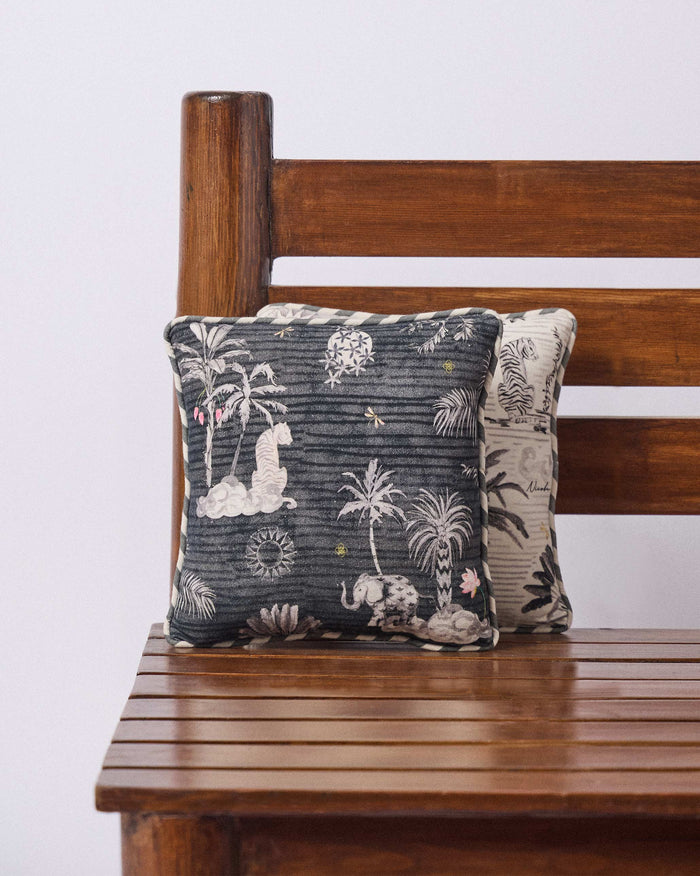 Charcoal Ele Car Cushion with grey elephants and palm trees.