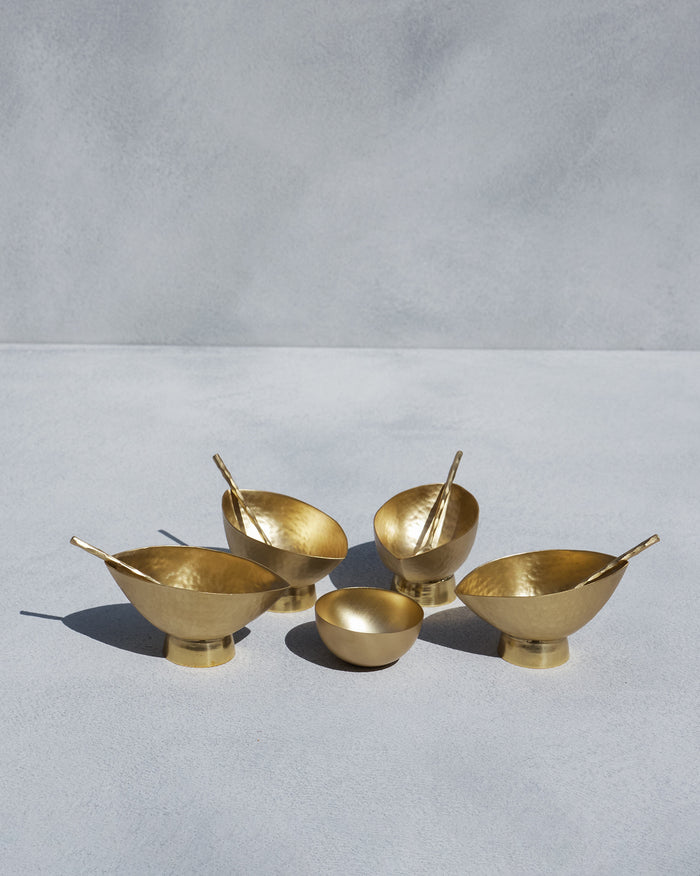 Chakra Gelato Cups in gold brass with matching spoons and a small bowl.