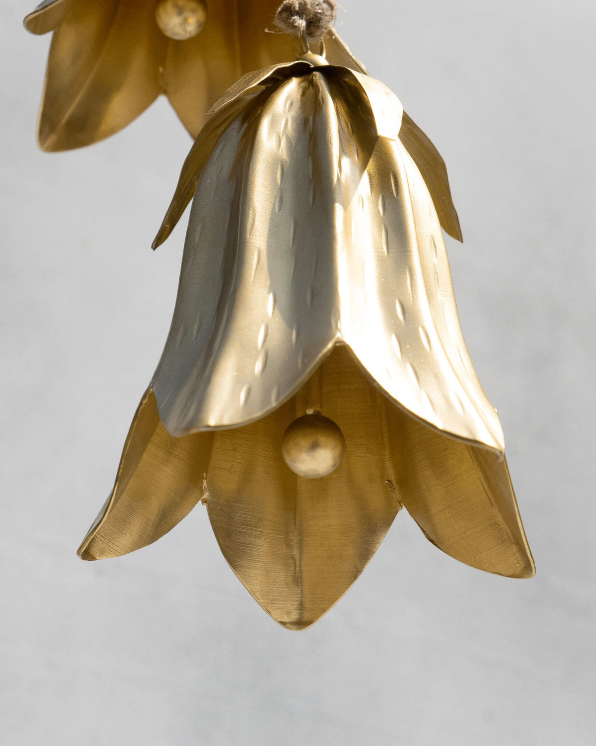 Close-up of hammered gold petals on a Botanical Bell.