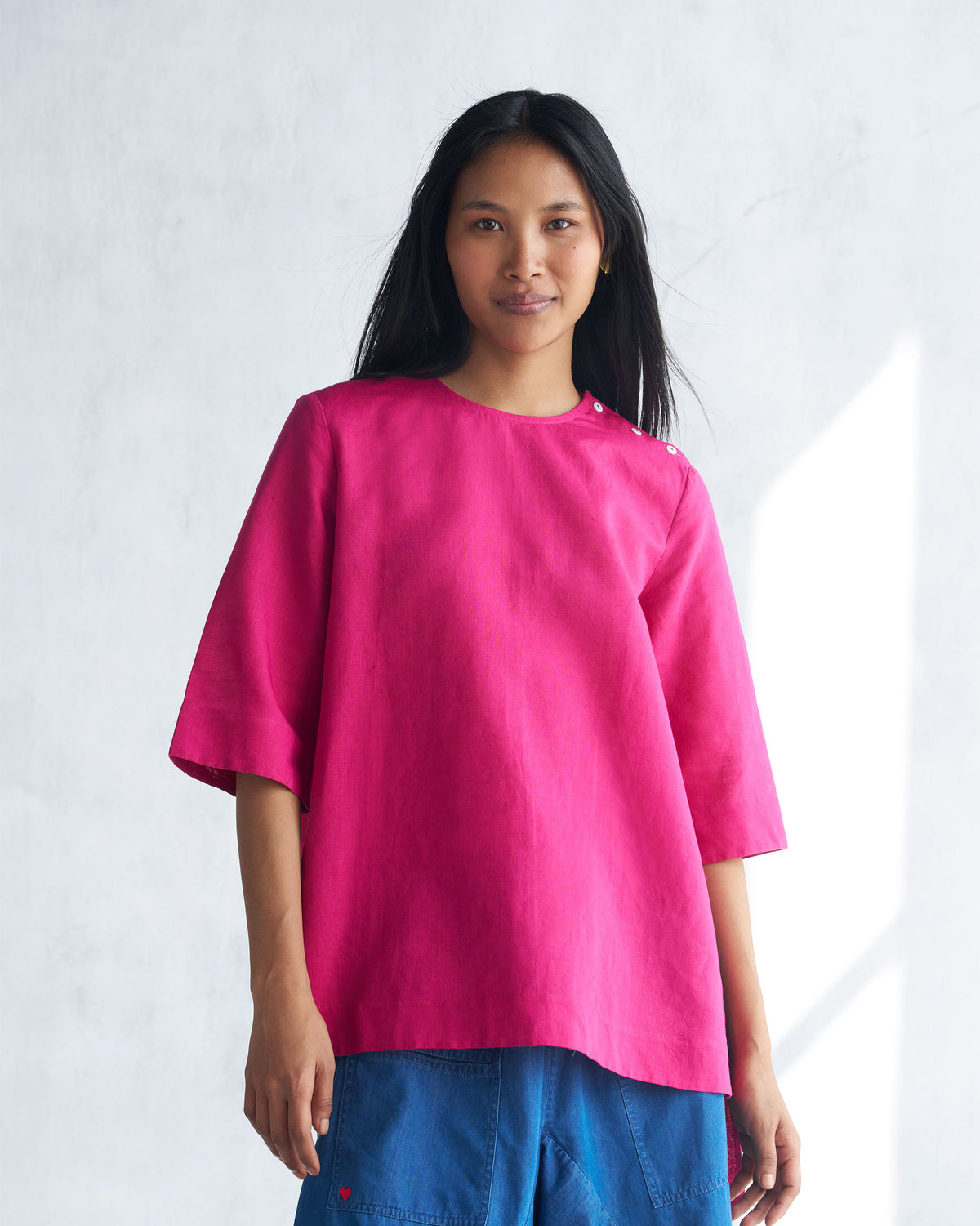 Person wearing a berry High Slit Top with shoulder buttons.