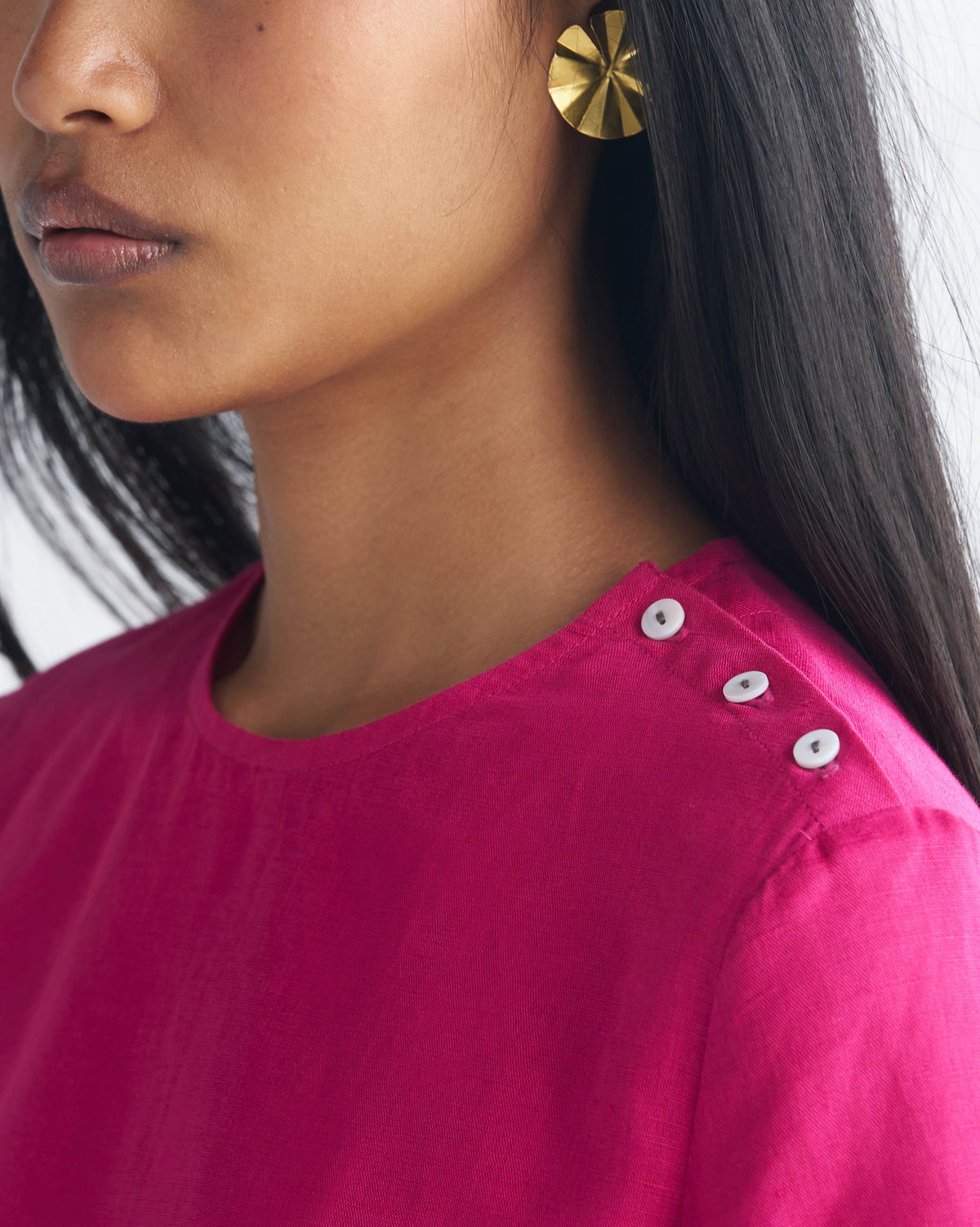 Close-up of a berry High Slit Top showing white buttons on the shoulder.