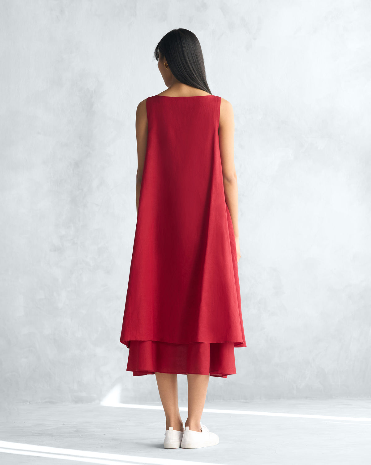 Back of a red Double layer dress worn by a person.