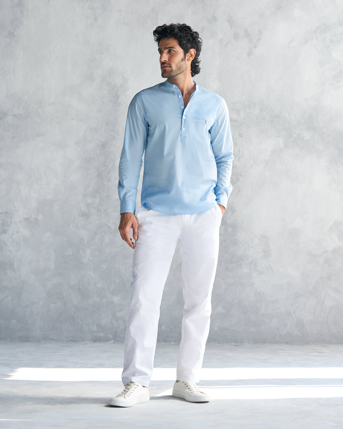 Light blue Pondicherry shirt worn full length with white trousers.