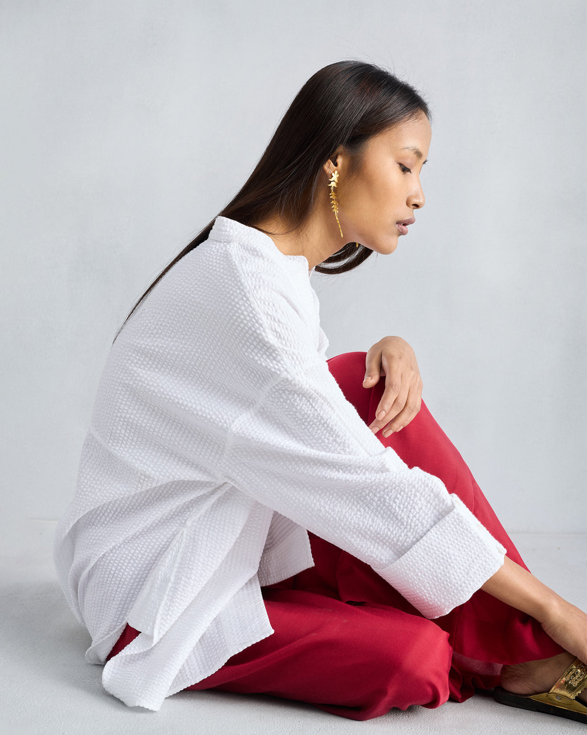 Side view of a white Cirrus seersucker shirt with wide folded cuffs.