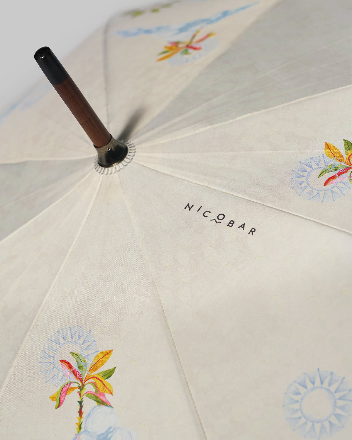 Close-up of the Zanzibar Umbrella canopy showing its palm, flower and sun motifs.