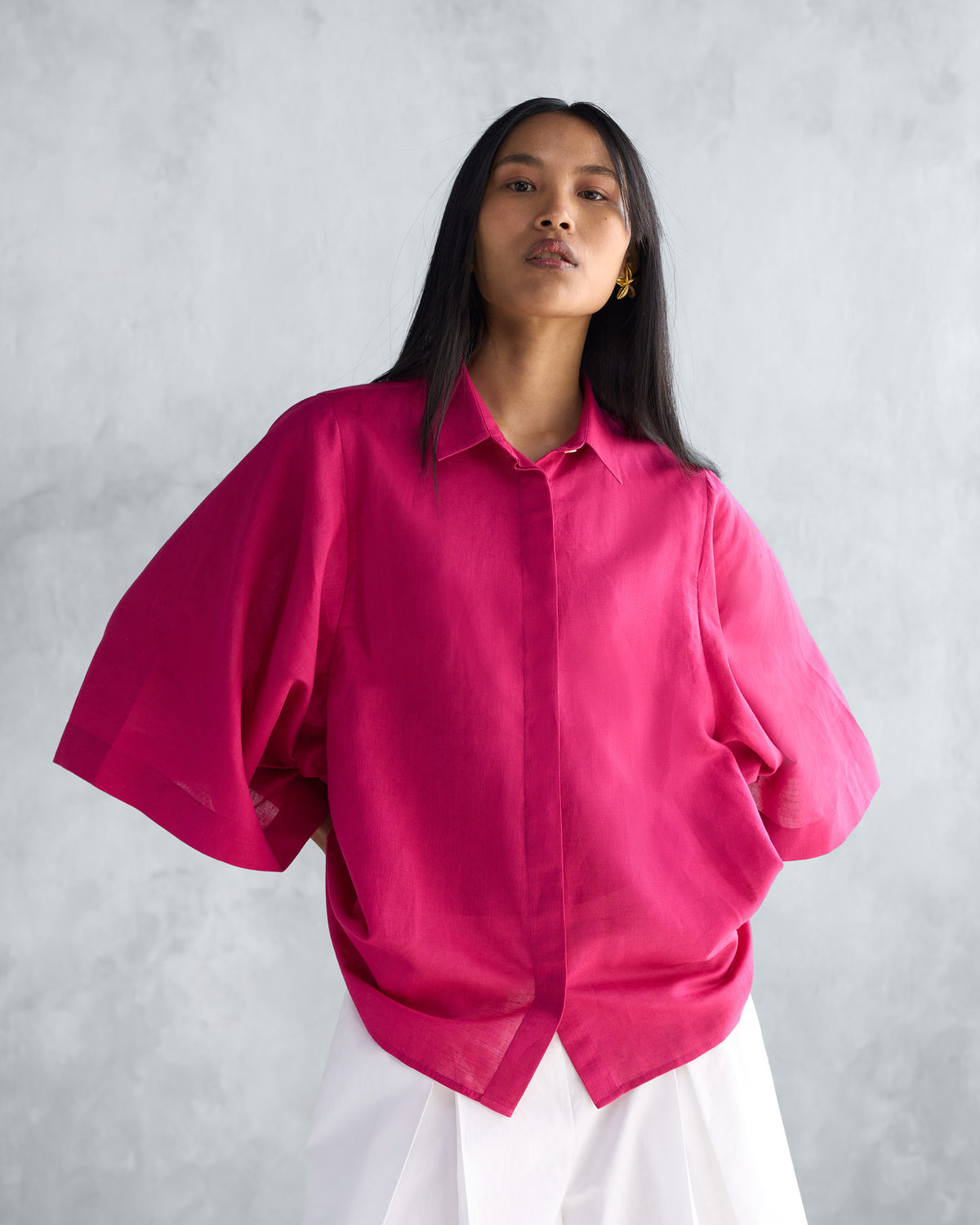 Person wearing a berry Drop Armhole Shirt with wide flared sleeves.