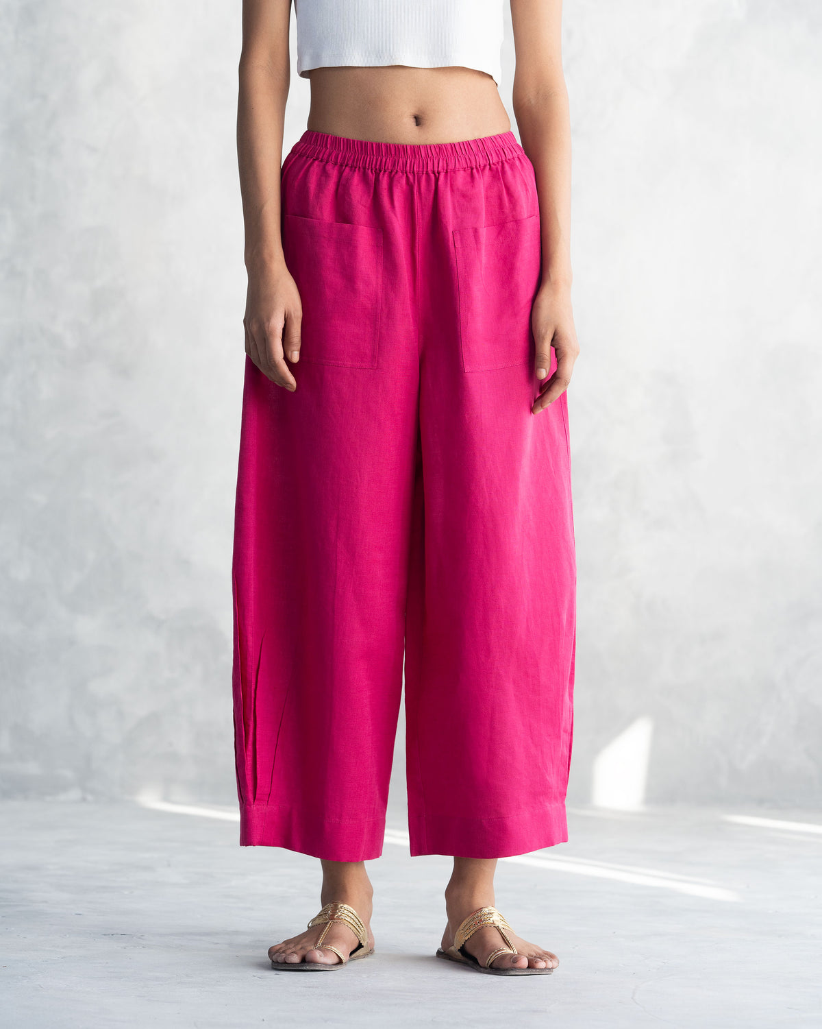 Person wearing berry Serene pants with wide legs and patch pockets.