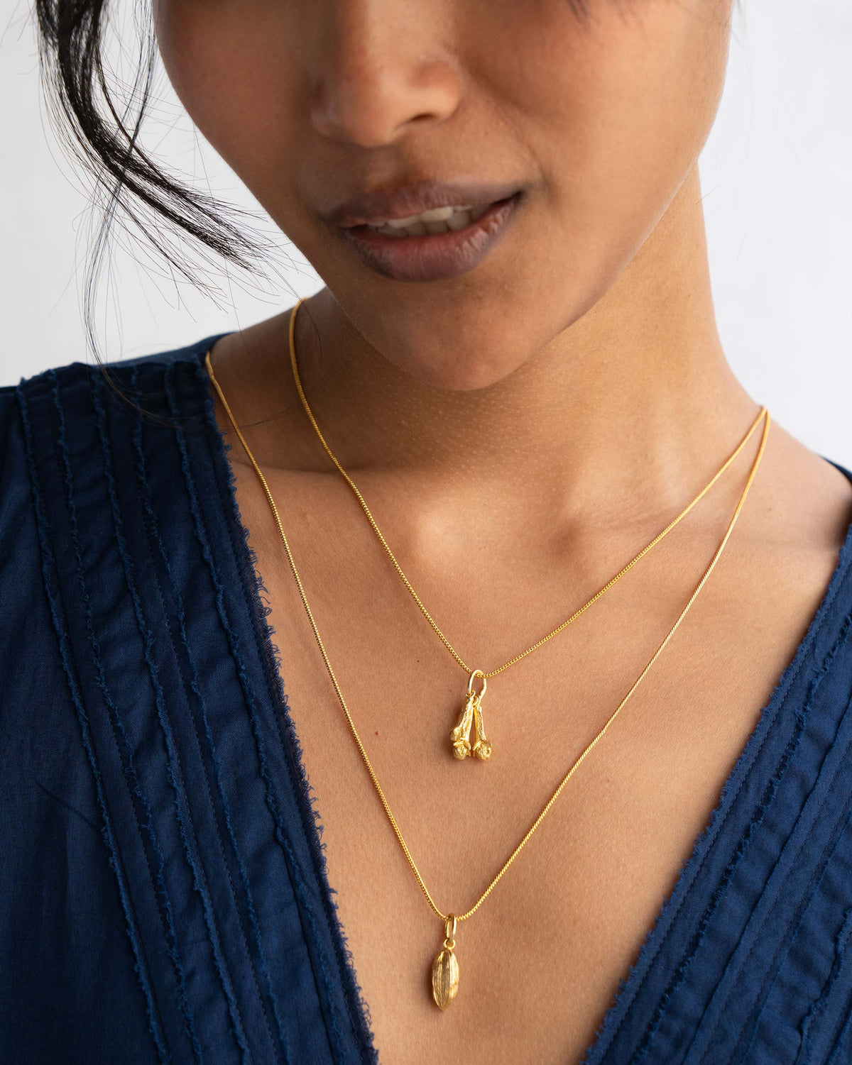 Gold clove charms layered with a longer spice charm.
