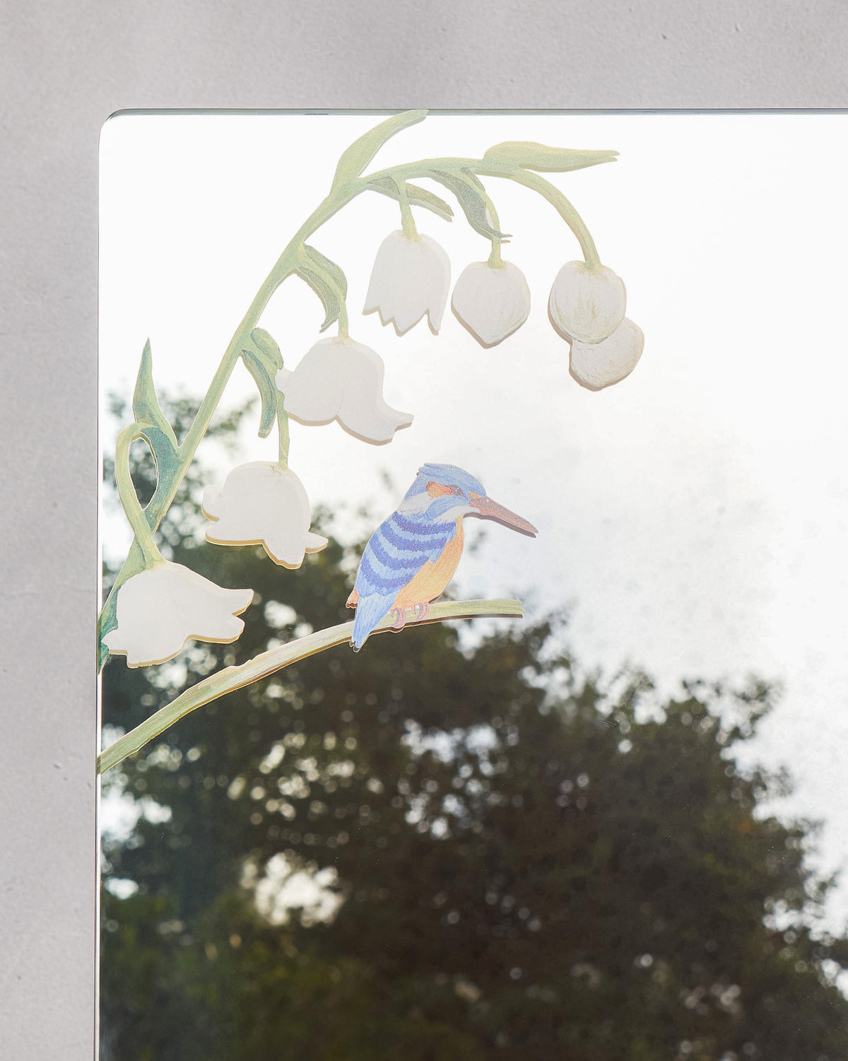 Close-up of the Kingfisher Mirror showing a kingfisher on a lily-of-the-valley branch.