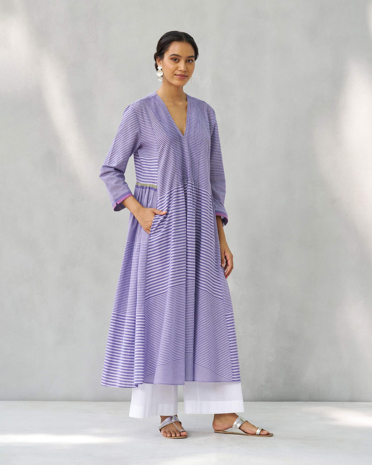 Person wearing a purple and white Pintuck kurta with a flared A-line silhouette.