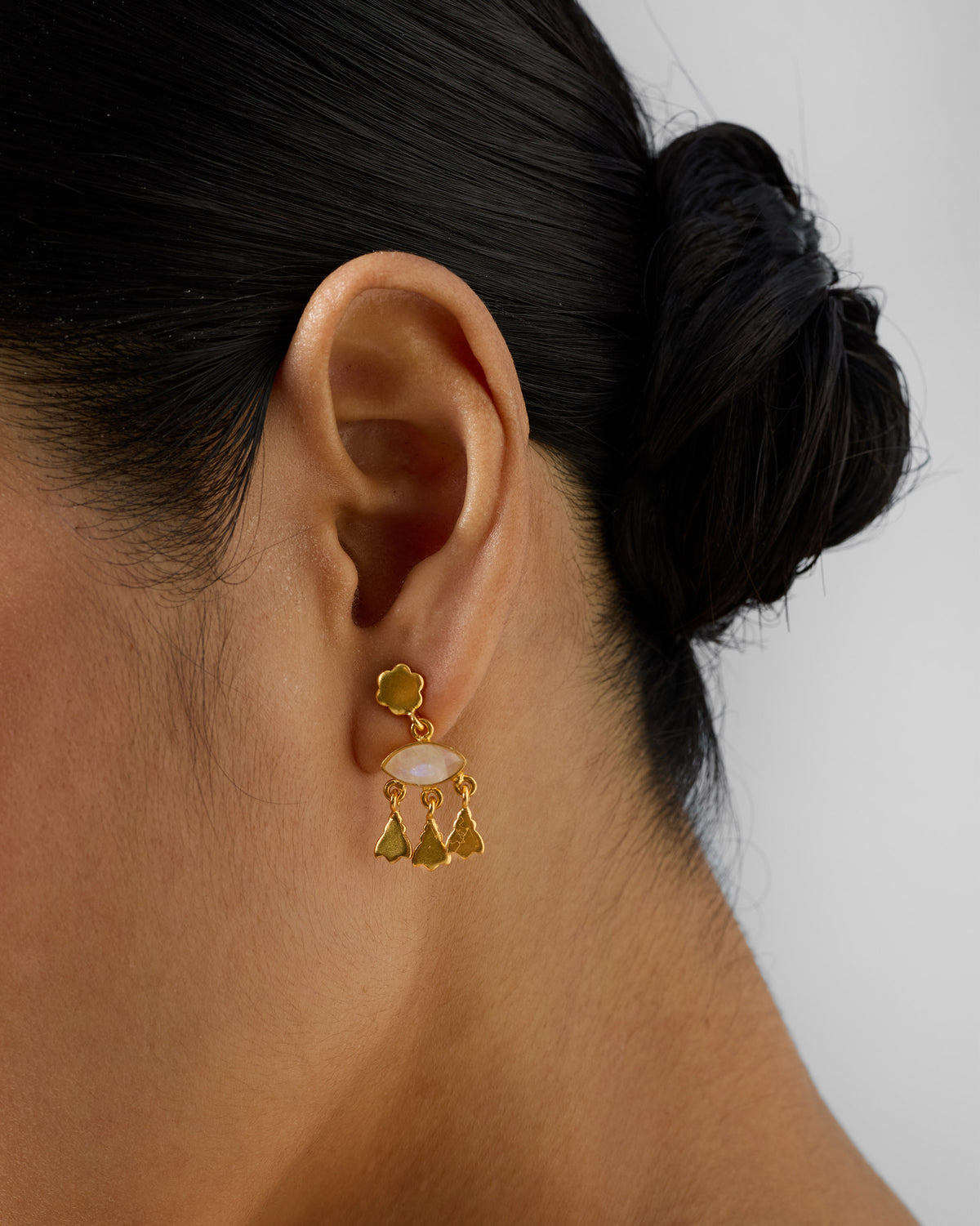 Side profile of gold Jhalak earrings with a moonstone drop.