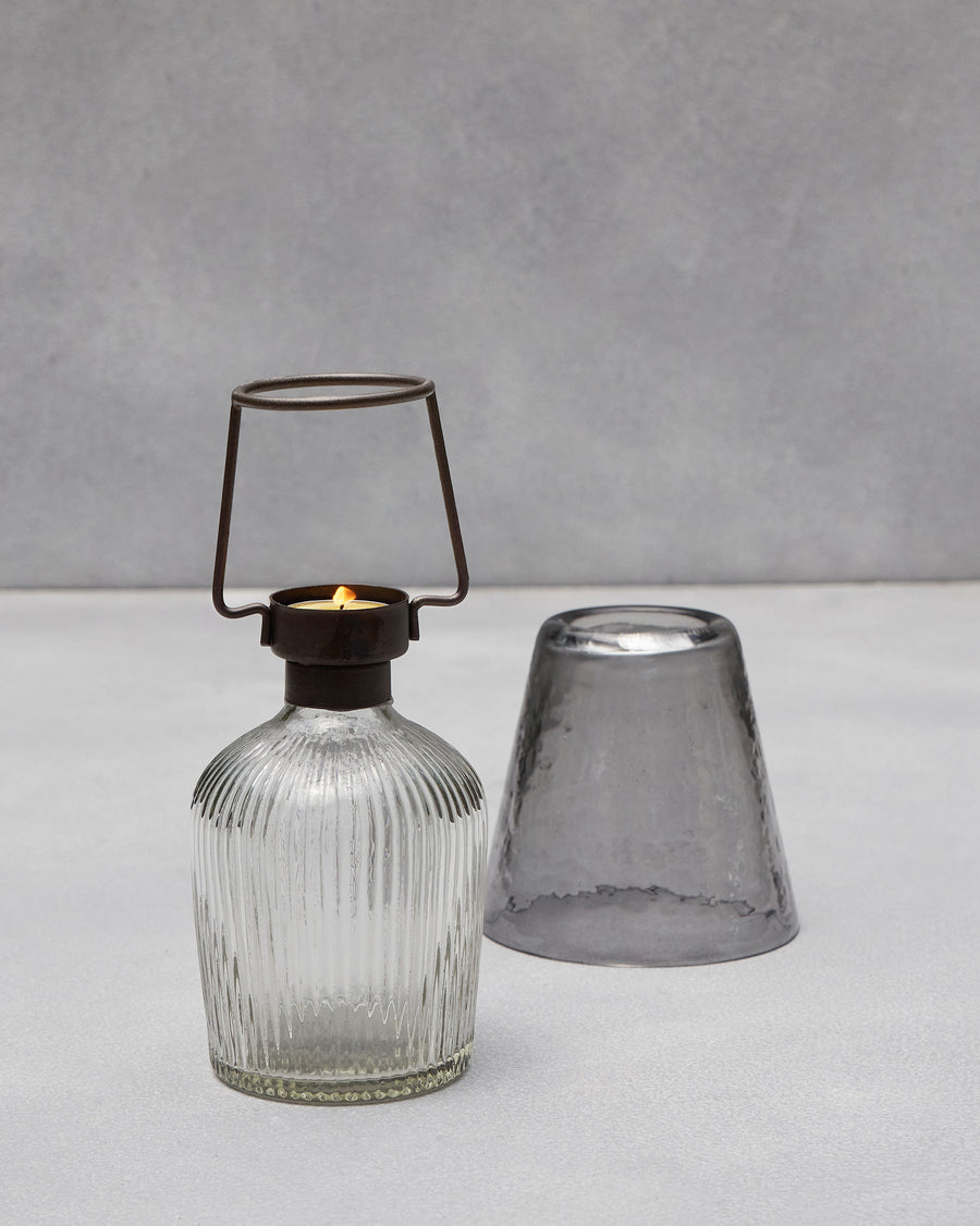 The votive with its shade lifted off.