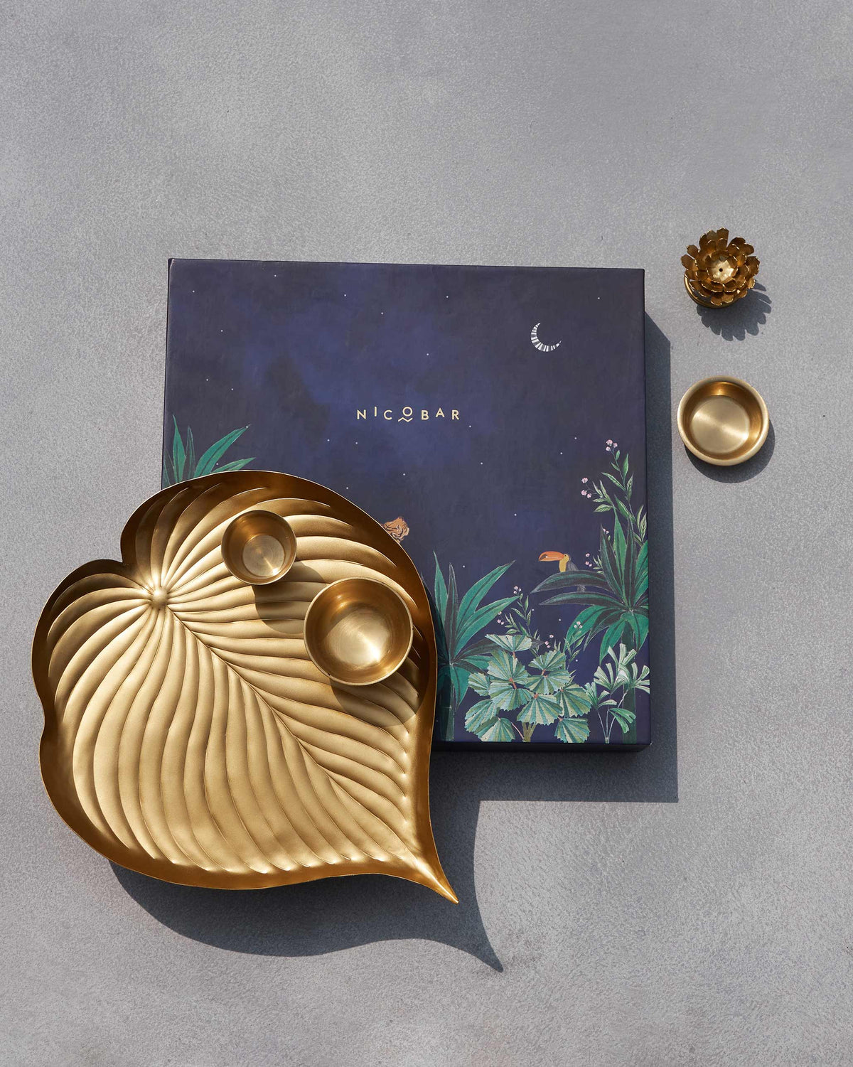 Asfar pooja set with brass leaf tray and navy Nicobar gift box.