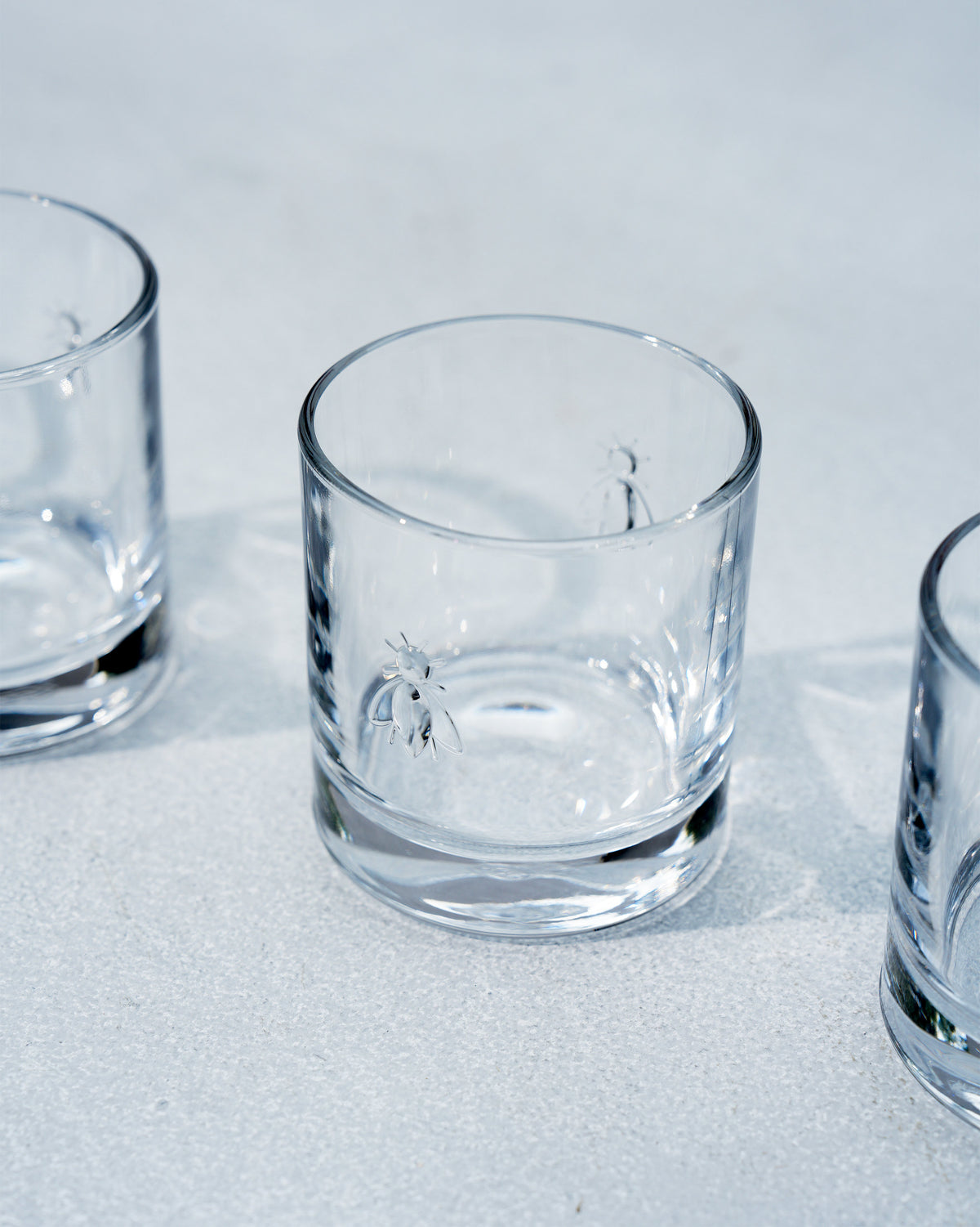 Close-up of a Bumble Bee whiskey glass with an embossed bee motif.