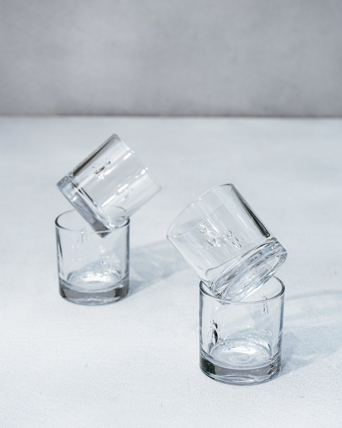 Two stacks of Bumble Bee whiskey glasses balanced at an angle.