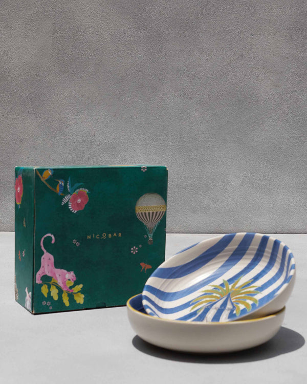 The bowls stacked beside a green Nicobar gift box