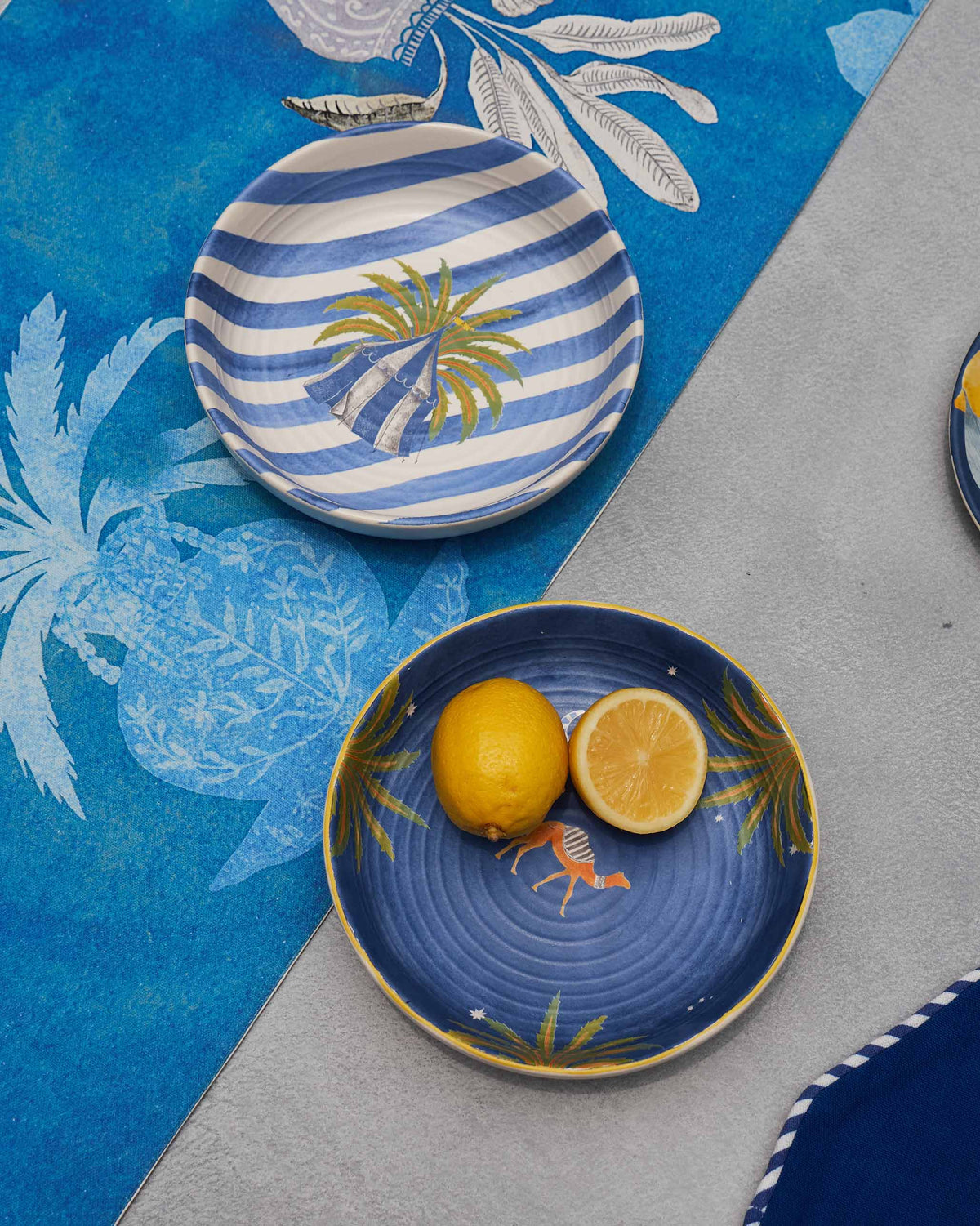 Pair of Sahara shallow bowls with palm motifs, one holding lemon halves.