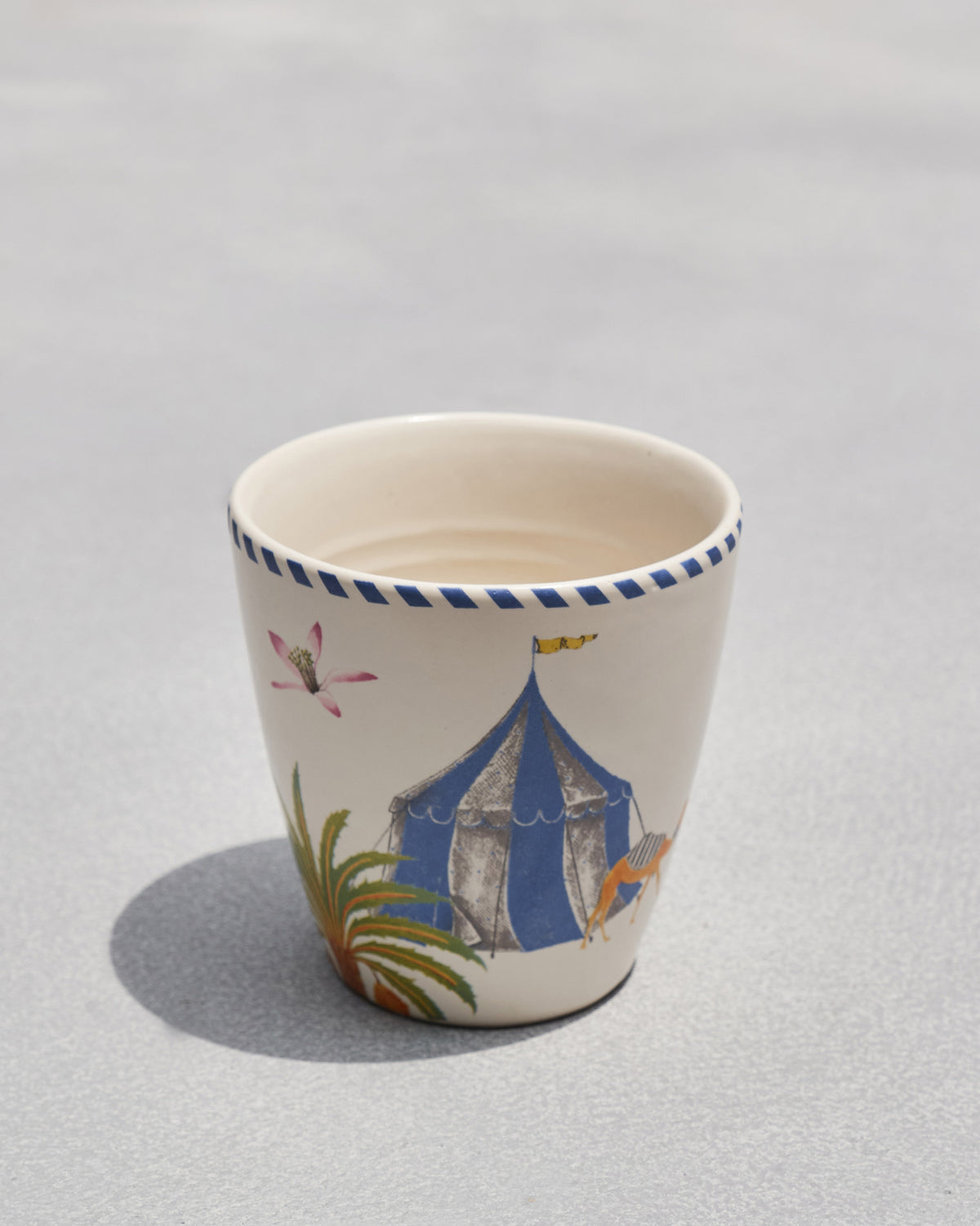 Sahara conical cup with no handle, showing a blue tent and palm tree.