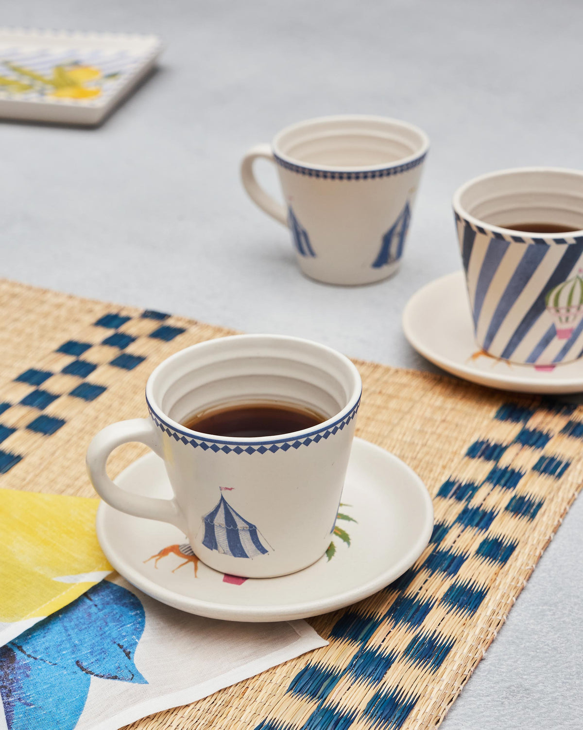 Sahara espresso mug with a circus tent print filled with coffee.