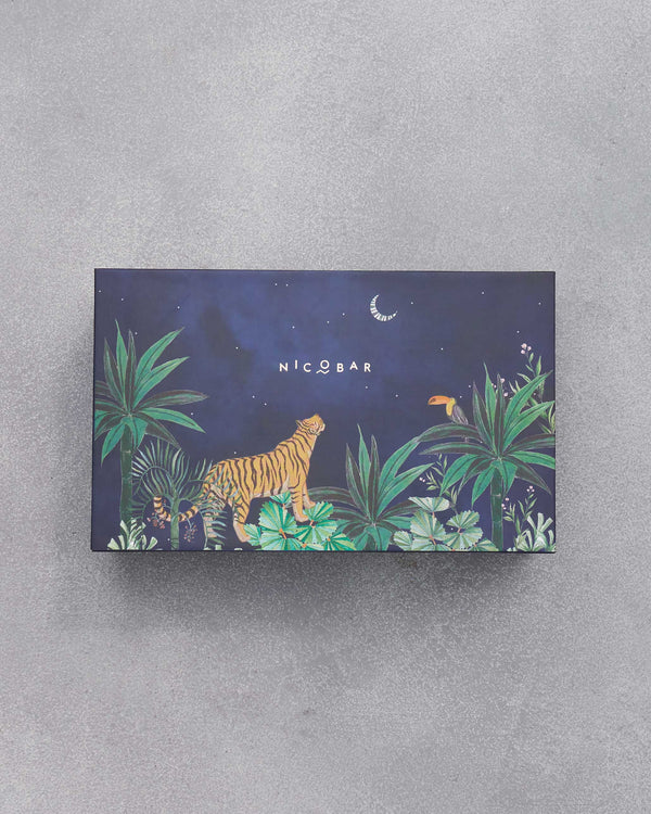 The closed navy box with a tiger and a toucan