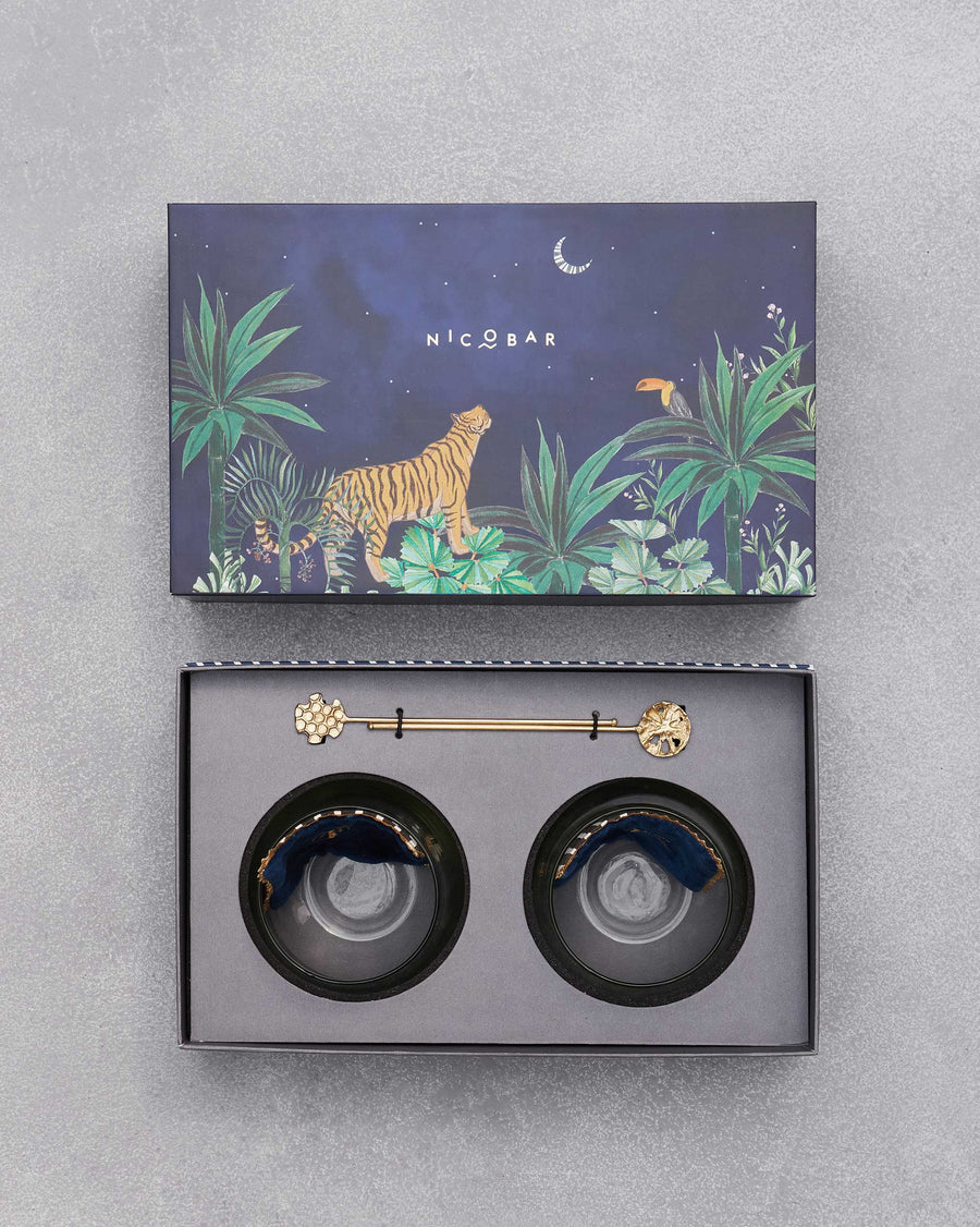 The open box with coasters and stirrers under the tiger lid