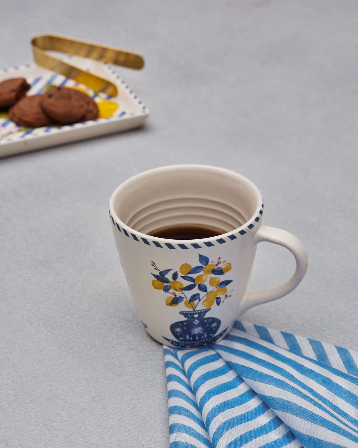 An Azraq napkin beside a mug of tea.