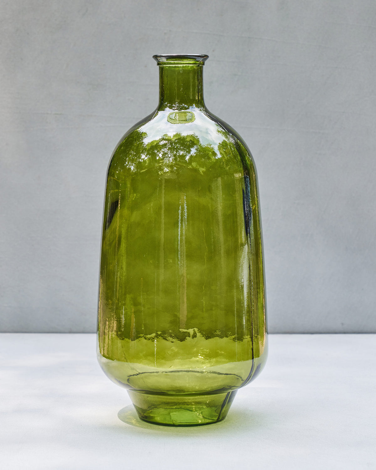 Tall translucent Jade Glass Vase with a narrow neck and rounded green body.