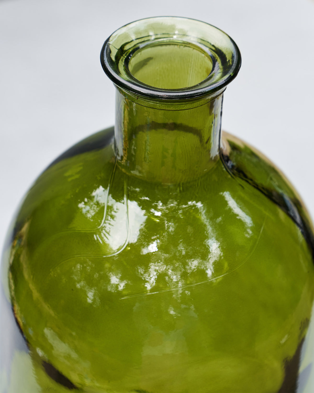 Close-up of the Jade Glass Vase’s flared rim and narrow green neck.