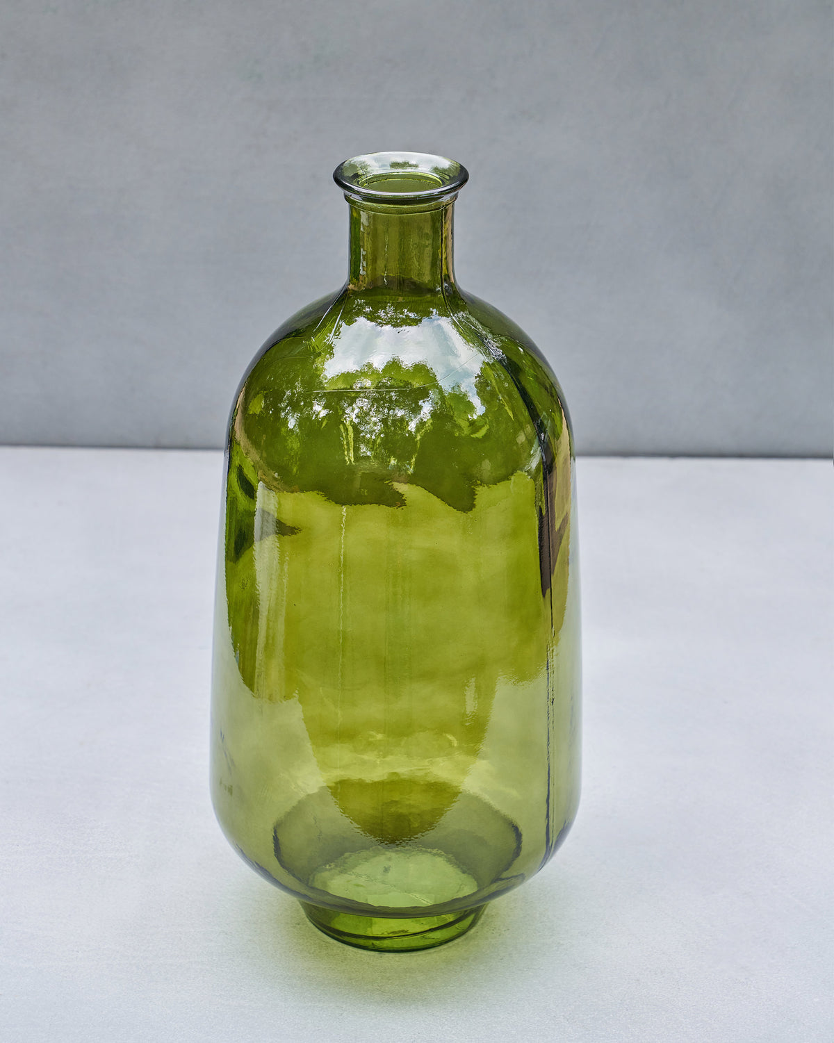 Front view of a bottle-shaped Jade Glass Vase in translucent green glass.