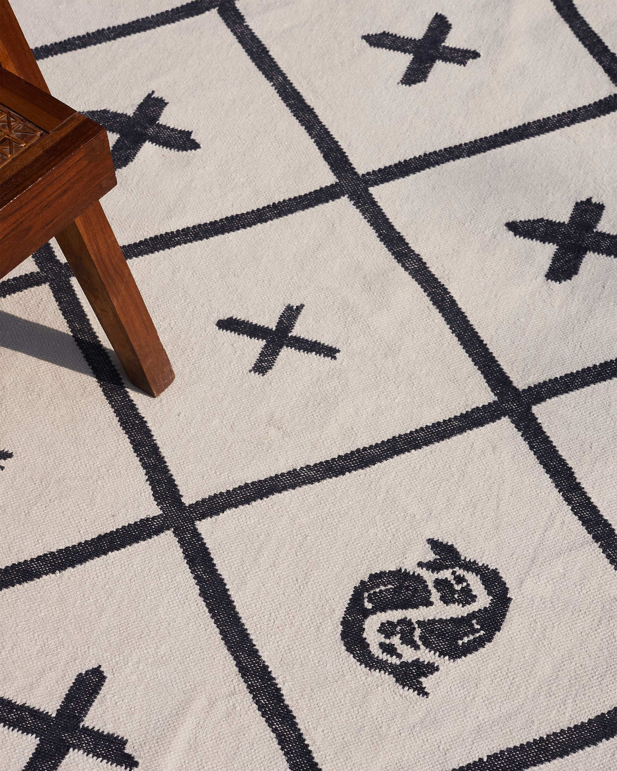 Angled close-up of the Morocco tiles rug showing its lattice and crosses.