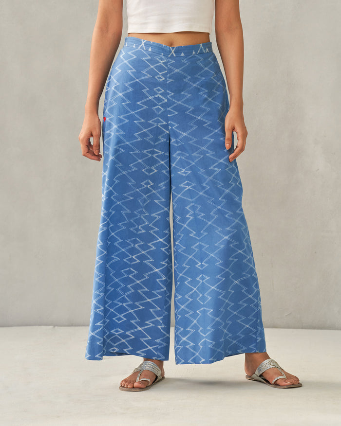 Person wearing blue Basic Pyjamas with a white zigzag print.