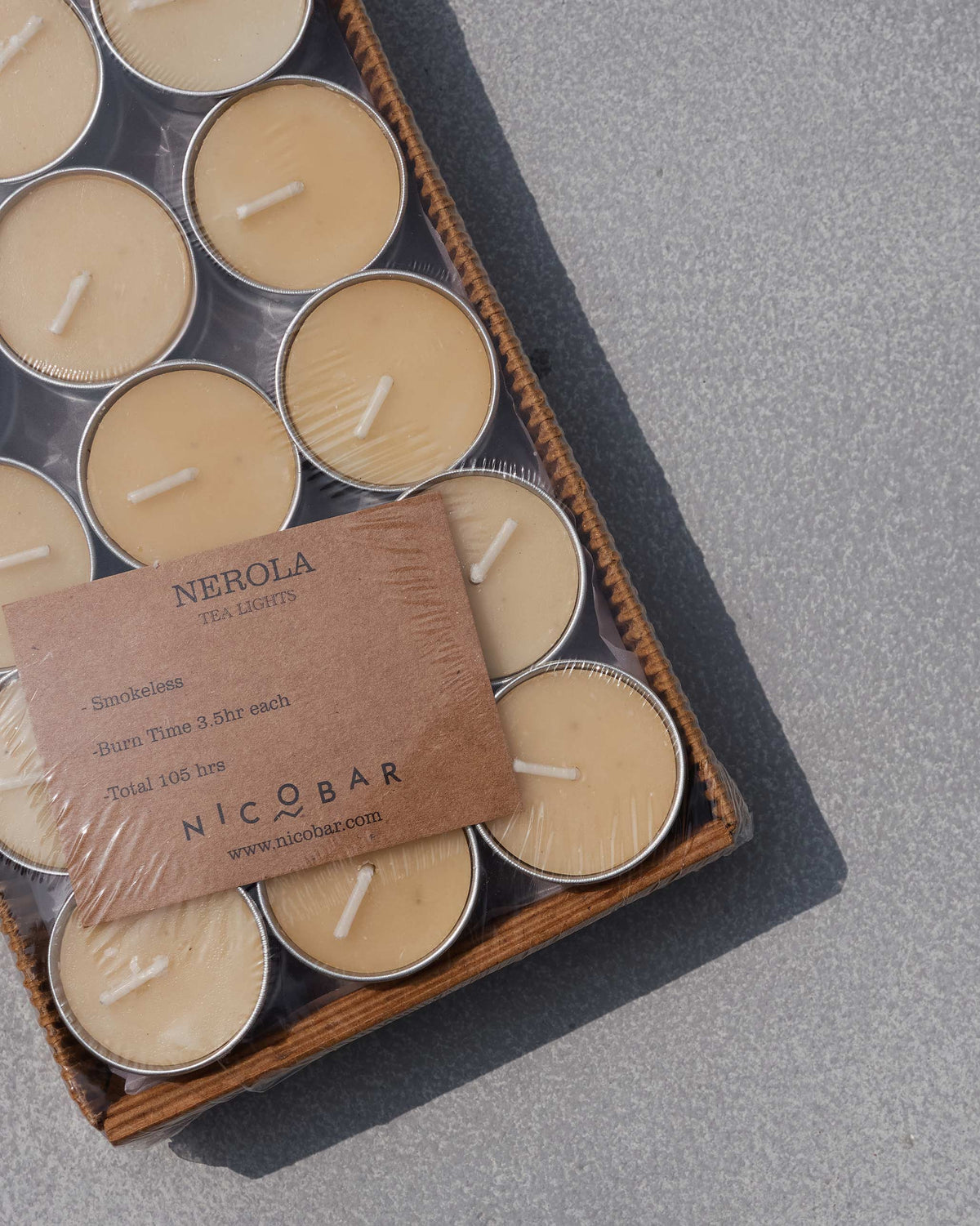 Nerola tealights packed in silver cups inside a shrink-wrapped cardboard tray.