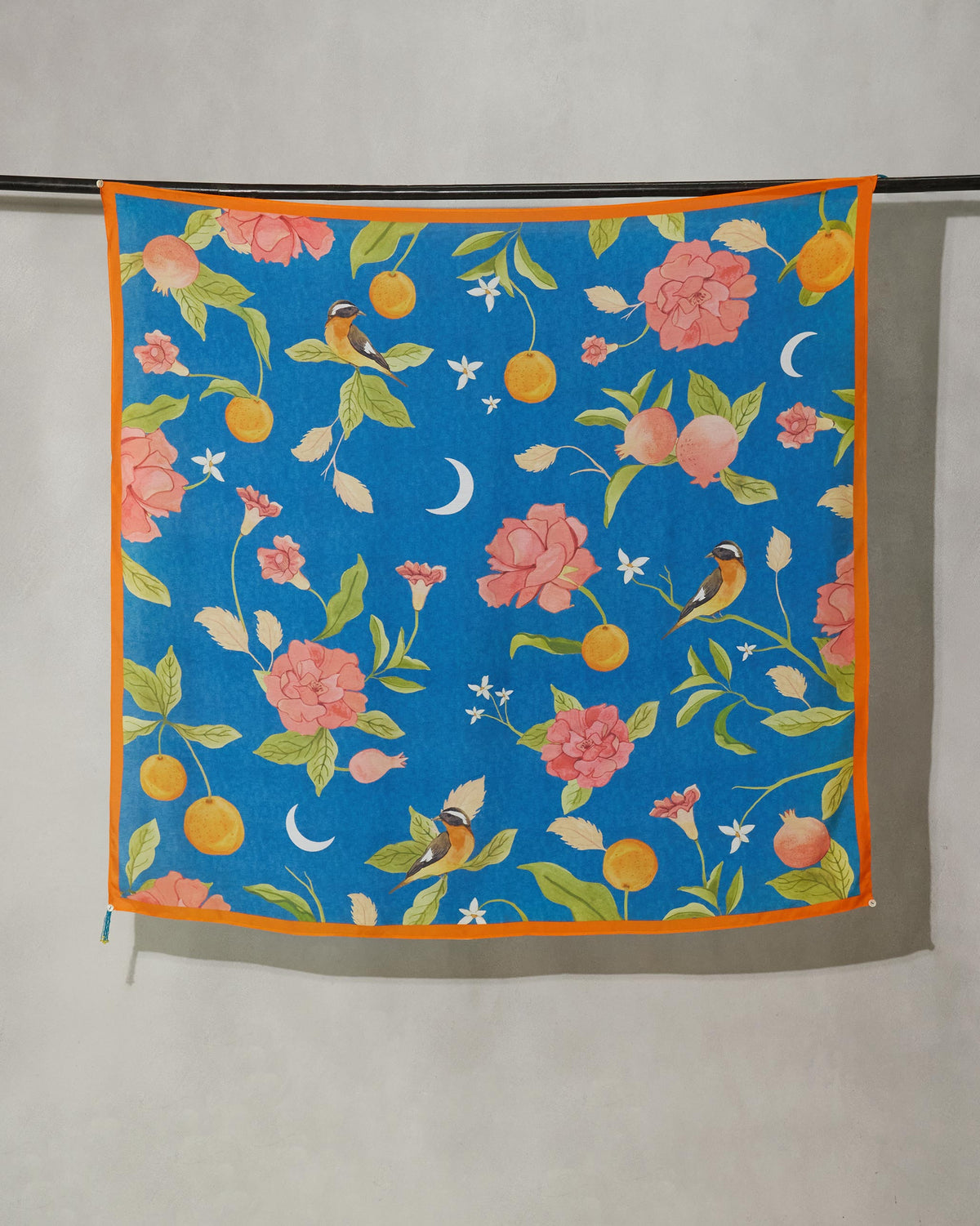 Midnight Garden scarf hung flat, showing birds, roses and crescent moons on blue.
