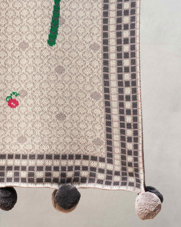 Close view of the checked border and pompoms