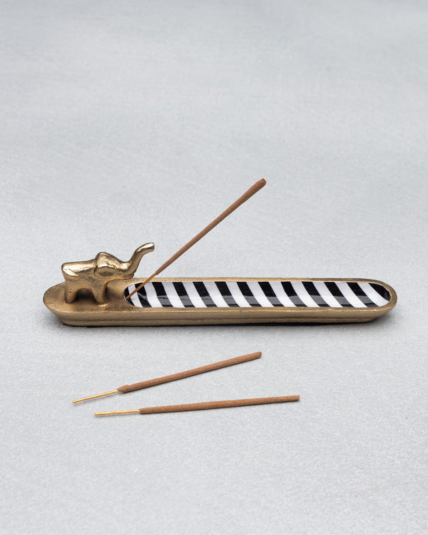 The holder with one stick in place and two more beside it