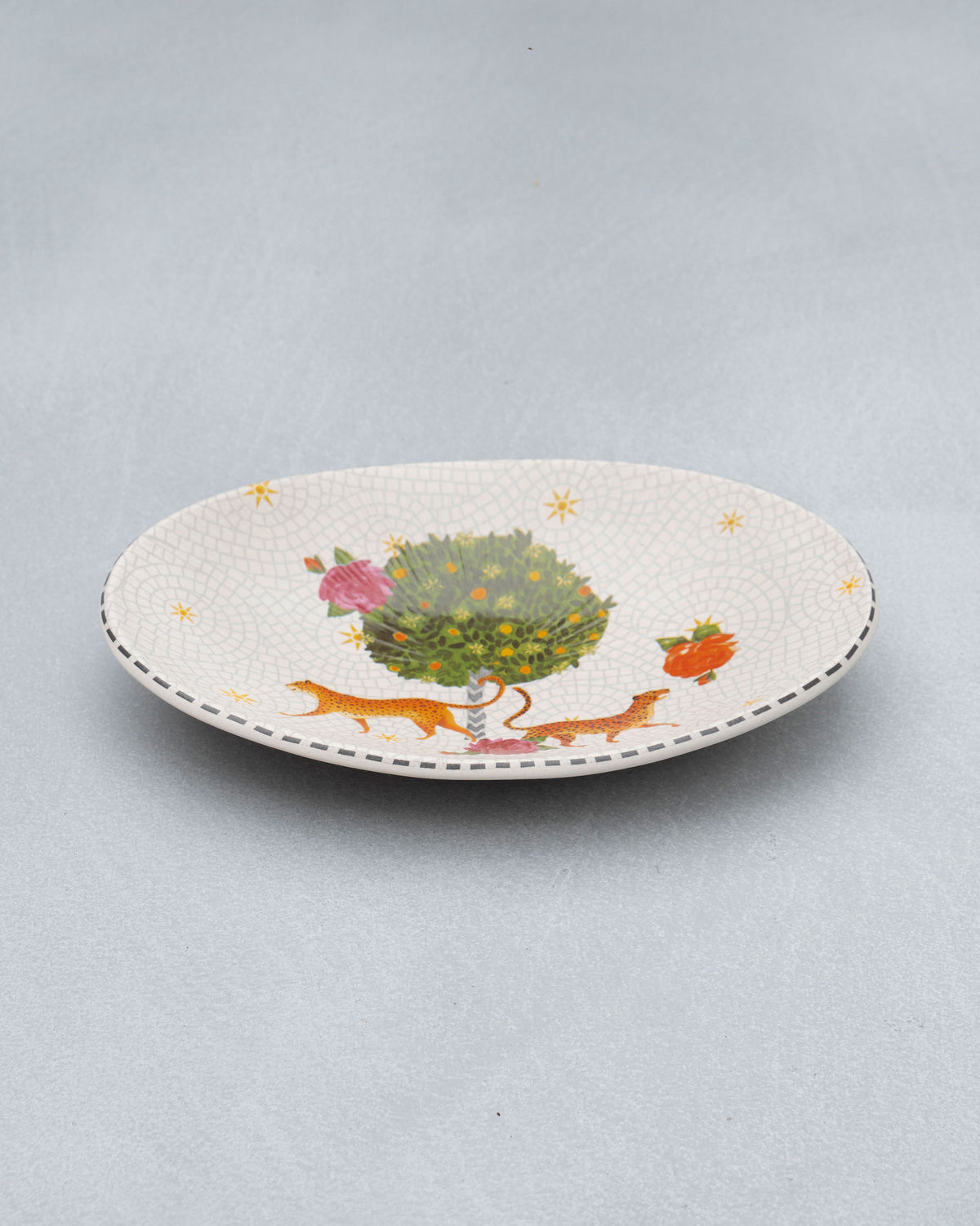Shallow Mirage oval platter with leopards under a fruit tree.