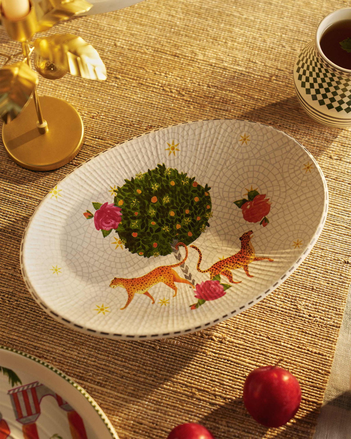 Mirage oval platter with leopards, a fruit tree and roses.