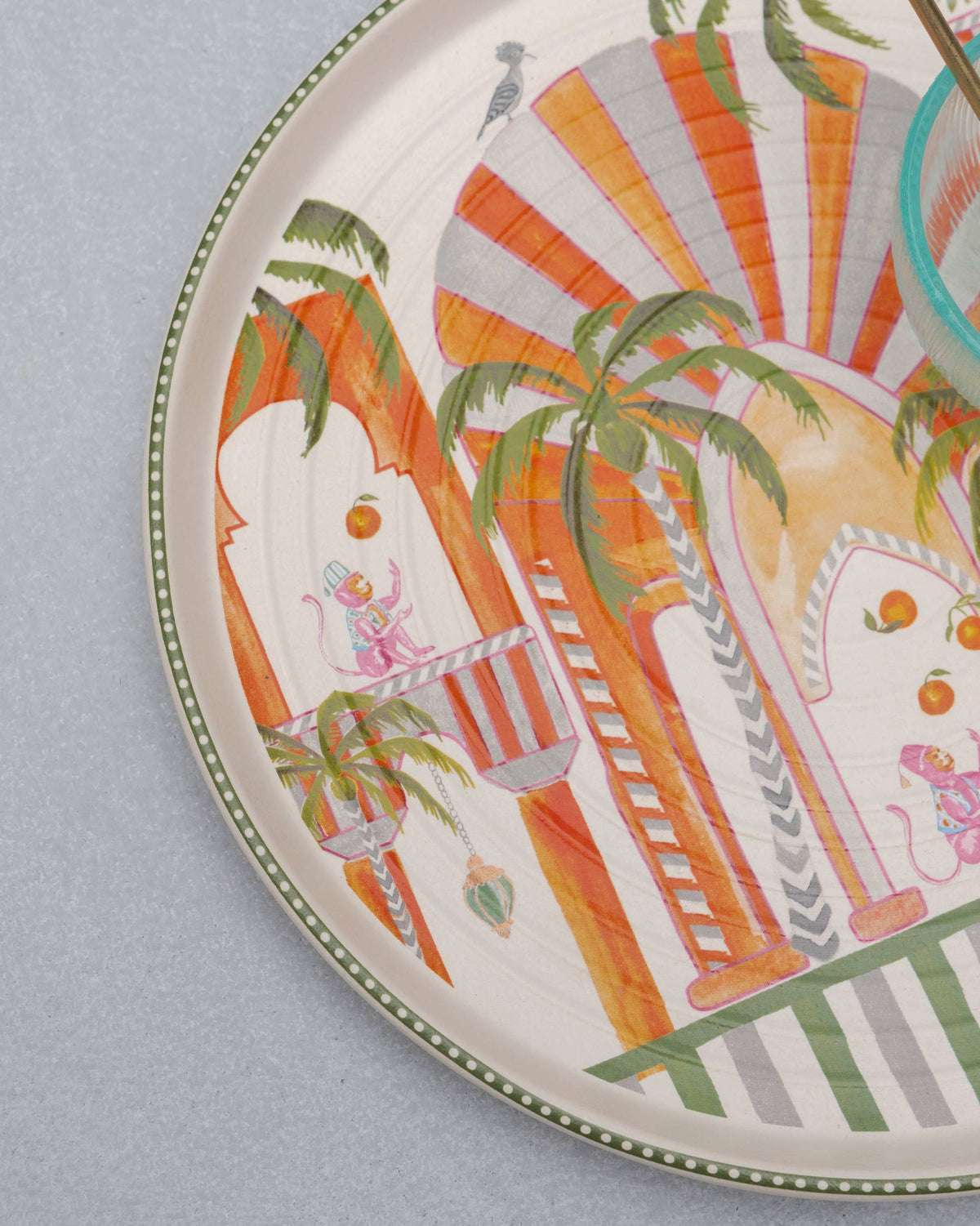Close-up of Mirage platter artwork with palace arches and pink monkeys.