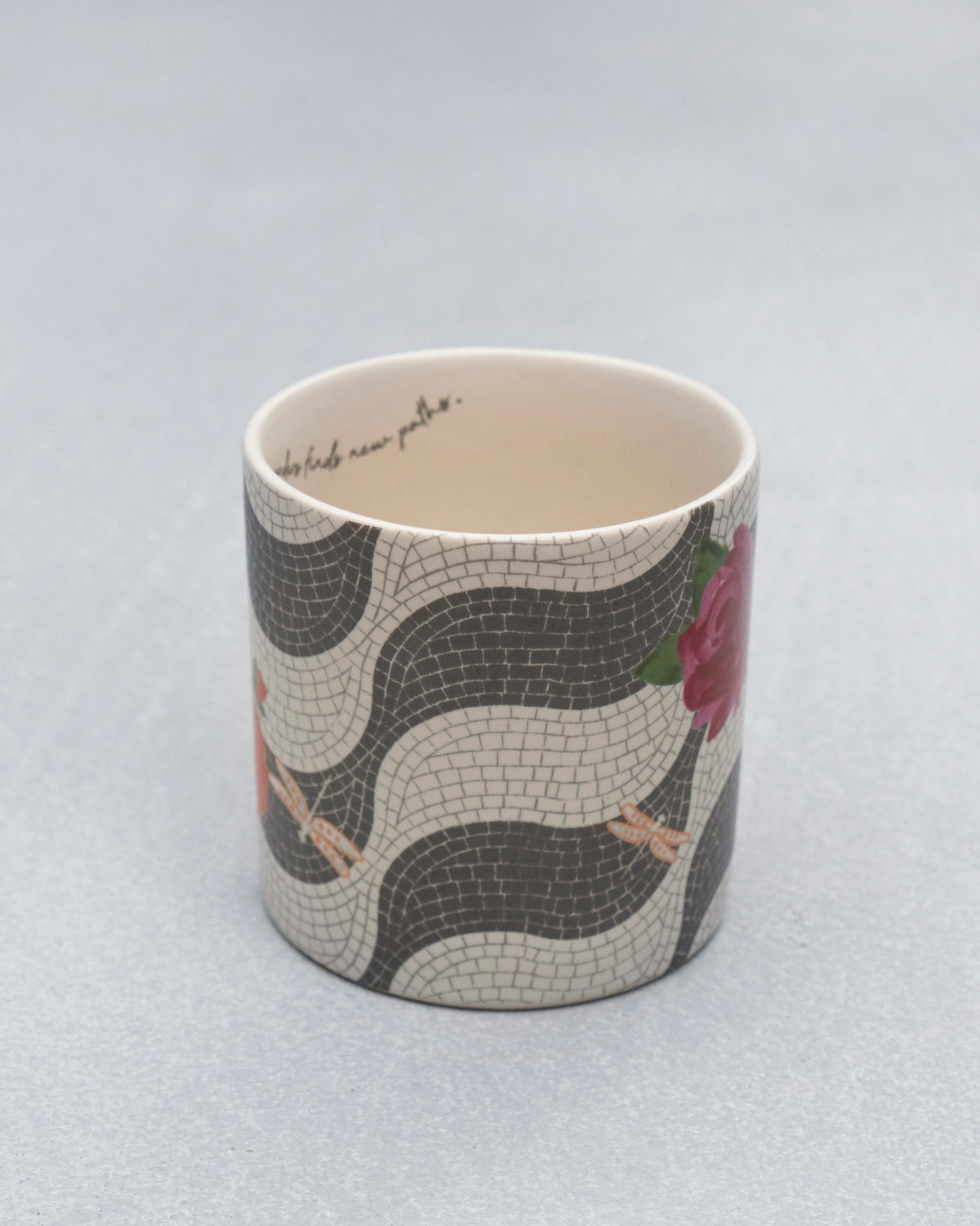 Looking into a Mosaic Bloom straight mug with mosaic exterior and cursive rim text.