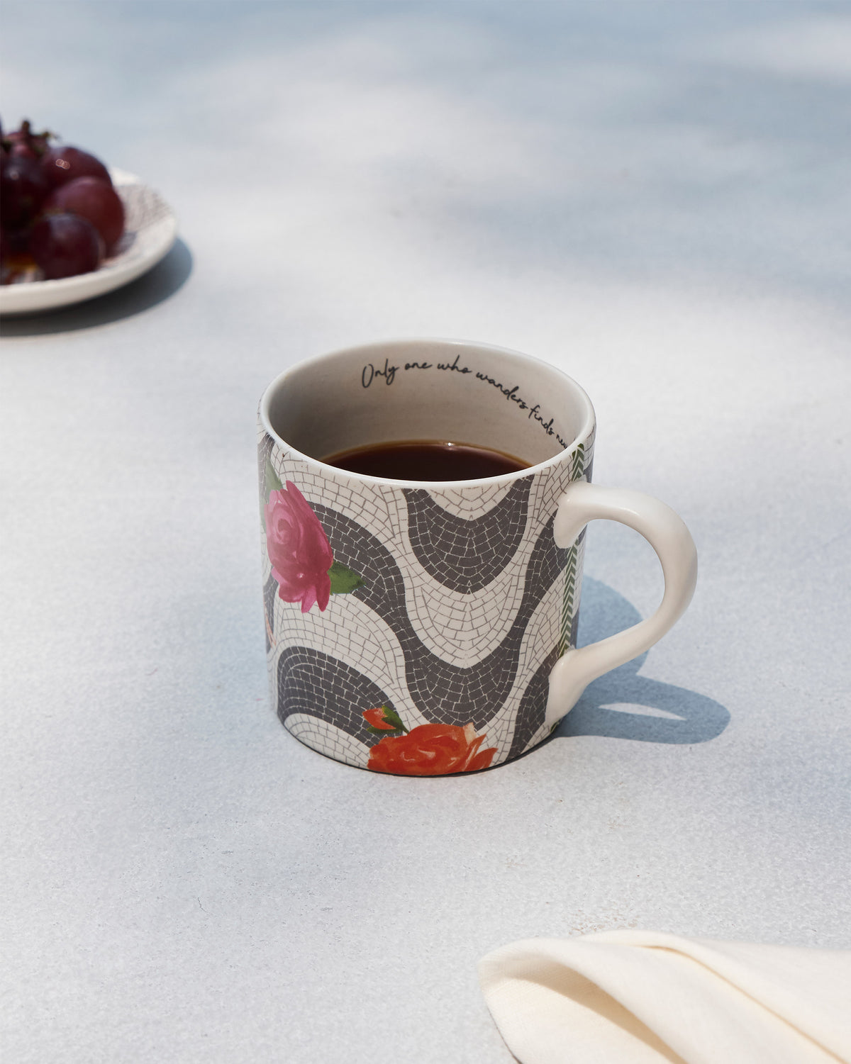 Mosaic Bloom straight mug filled with coffee, showing rose motifs on the mosaic print.