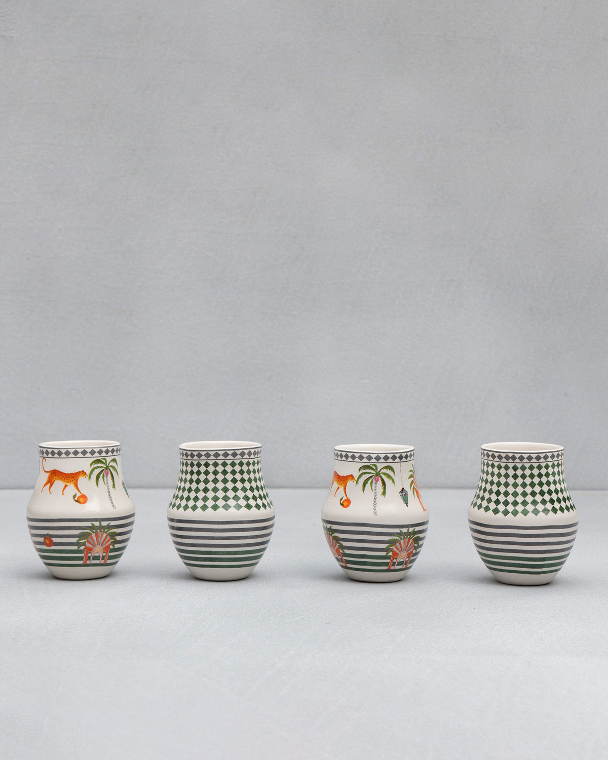 Row of four Dessert Palm Kulhars with tiger, palm and green stripe designs.
