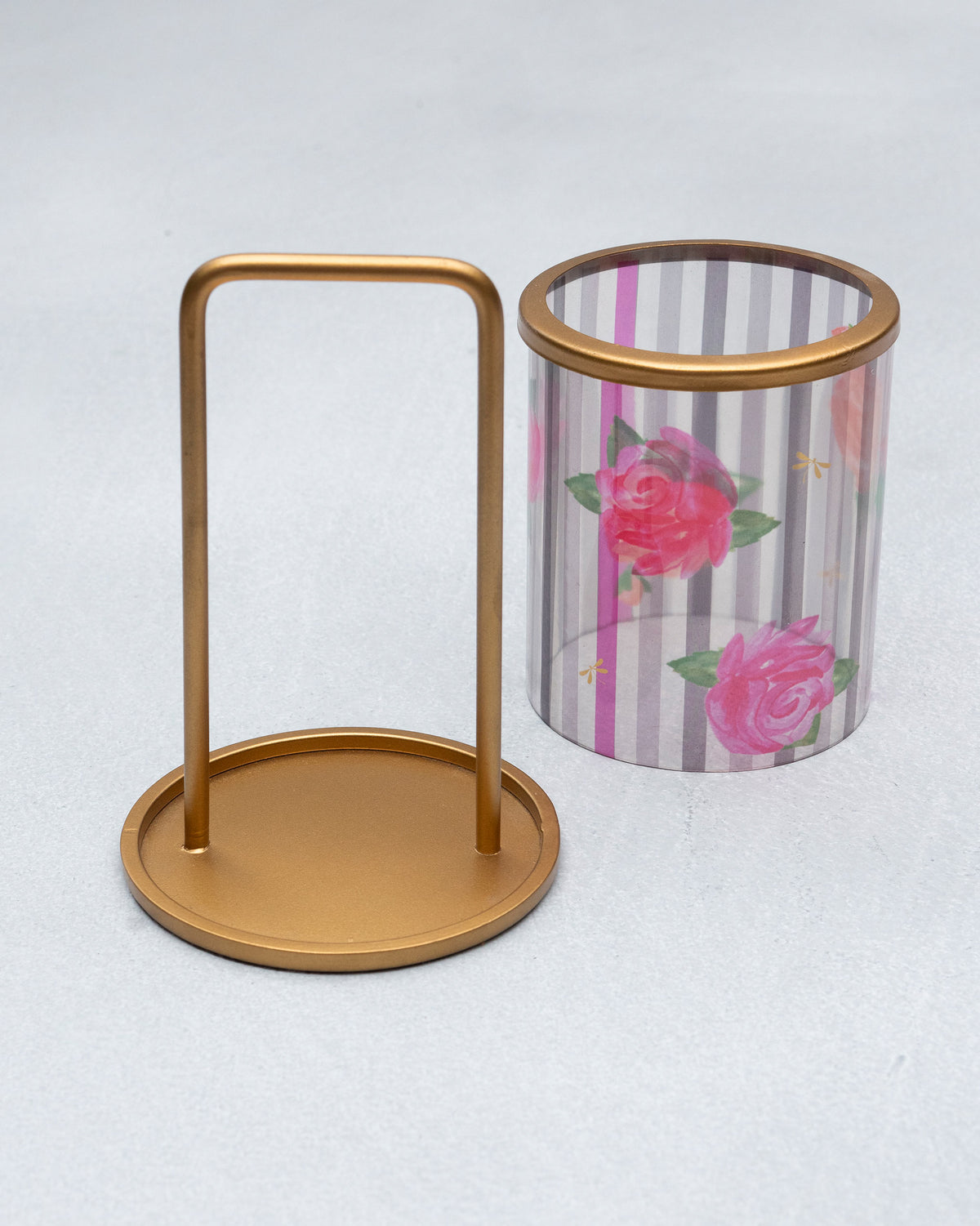 Striped Roses lantern glass sleeve shown beside its gold metal stand.